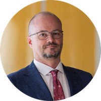 Professional image of housing researcher Dr Chris Martin