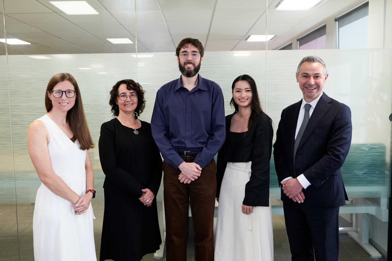 Group photo of AHURI Professional Services team standing together in office