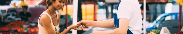 woman paying for groceries at register