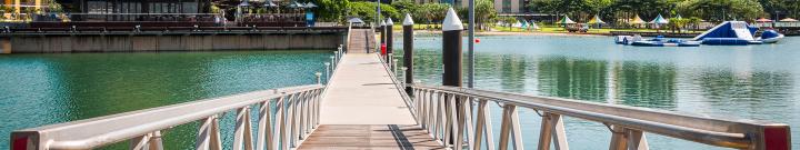 waterfront with bridge and grass area