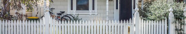 house with picket fence and bikes outside