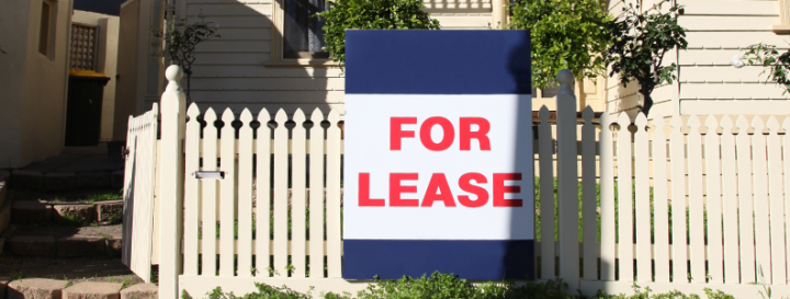 House with 'for lease' sign at front