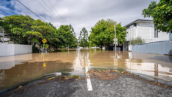 Ground level view of a flooded rural Australian street in daylight