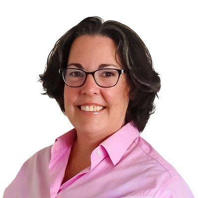 Photo of Rachel Hornsby. She has dark hair and is wearing glasses and a pink collared shirt.