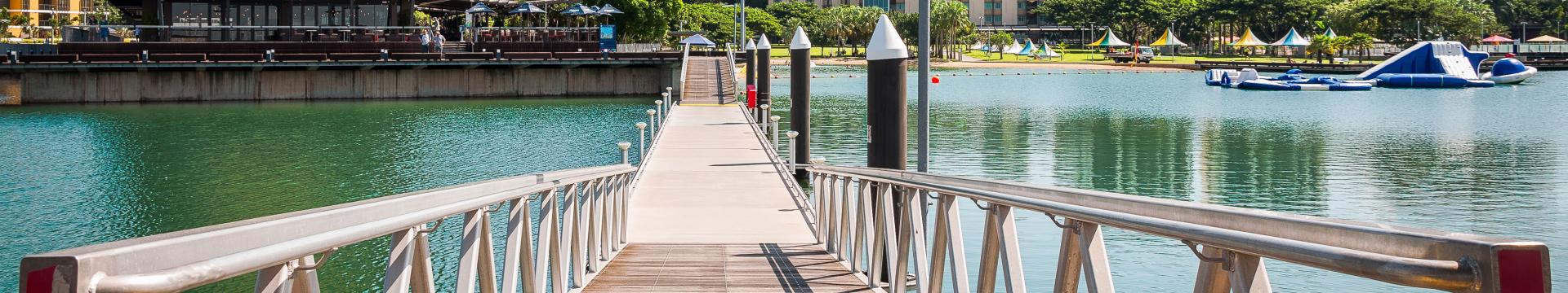 waterfront with bridge and grass area