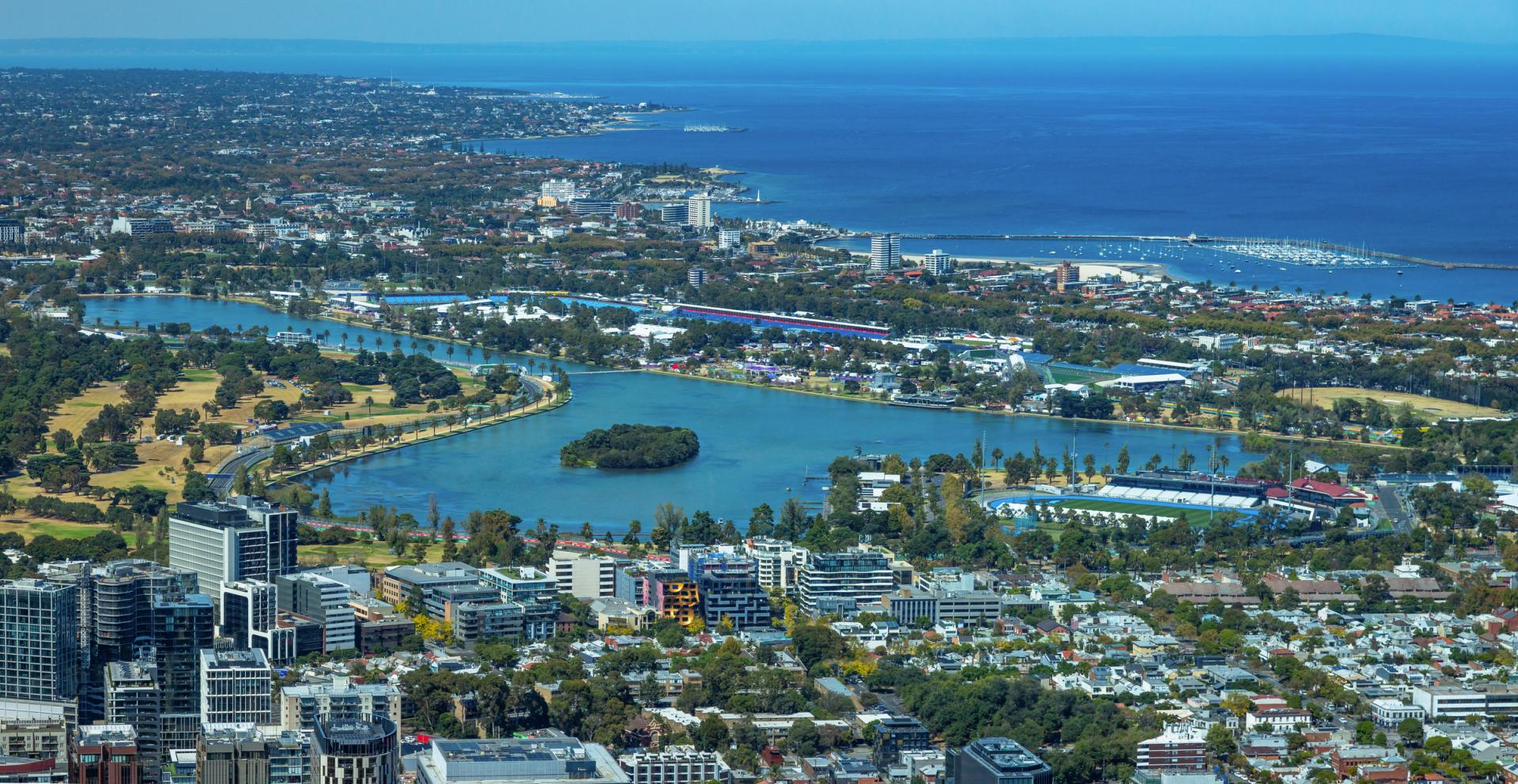 Aerial view of Albert Park, Melbourne and surrounding city and water in daylight