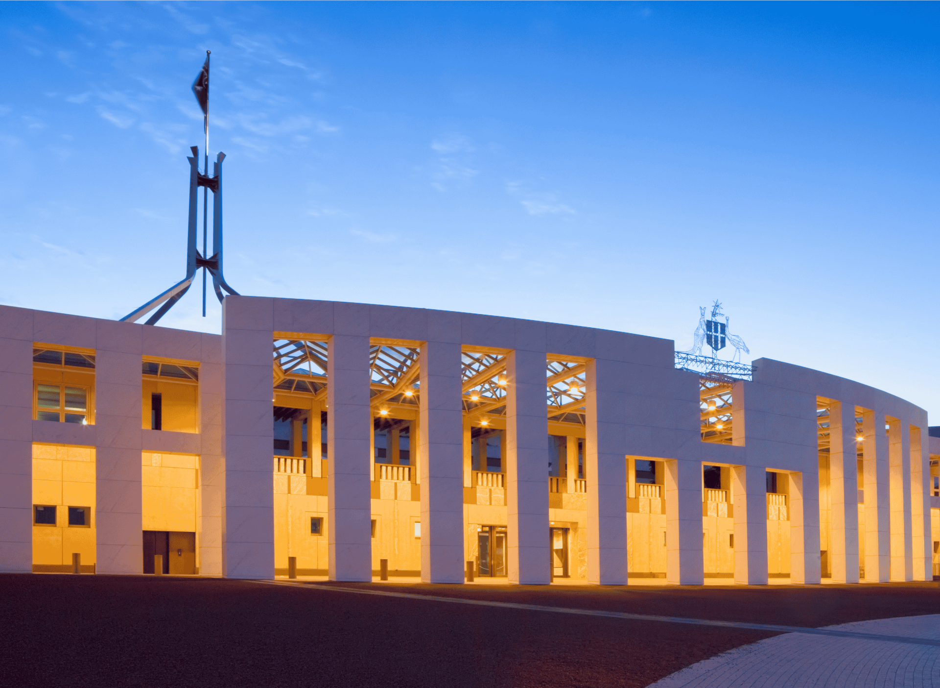 Image of parliament house at dusk with walkway illuminated